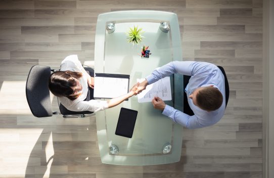 An overhead shot of two people in a meeting