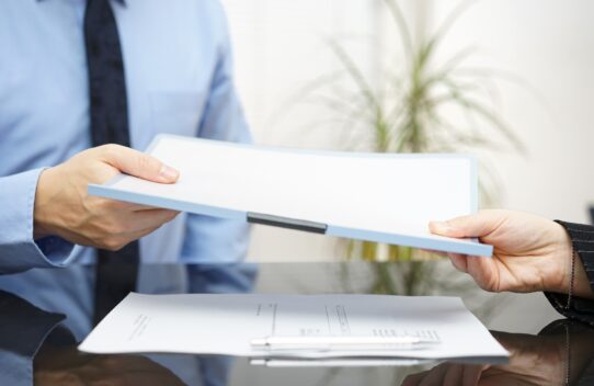 documents being handed over